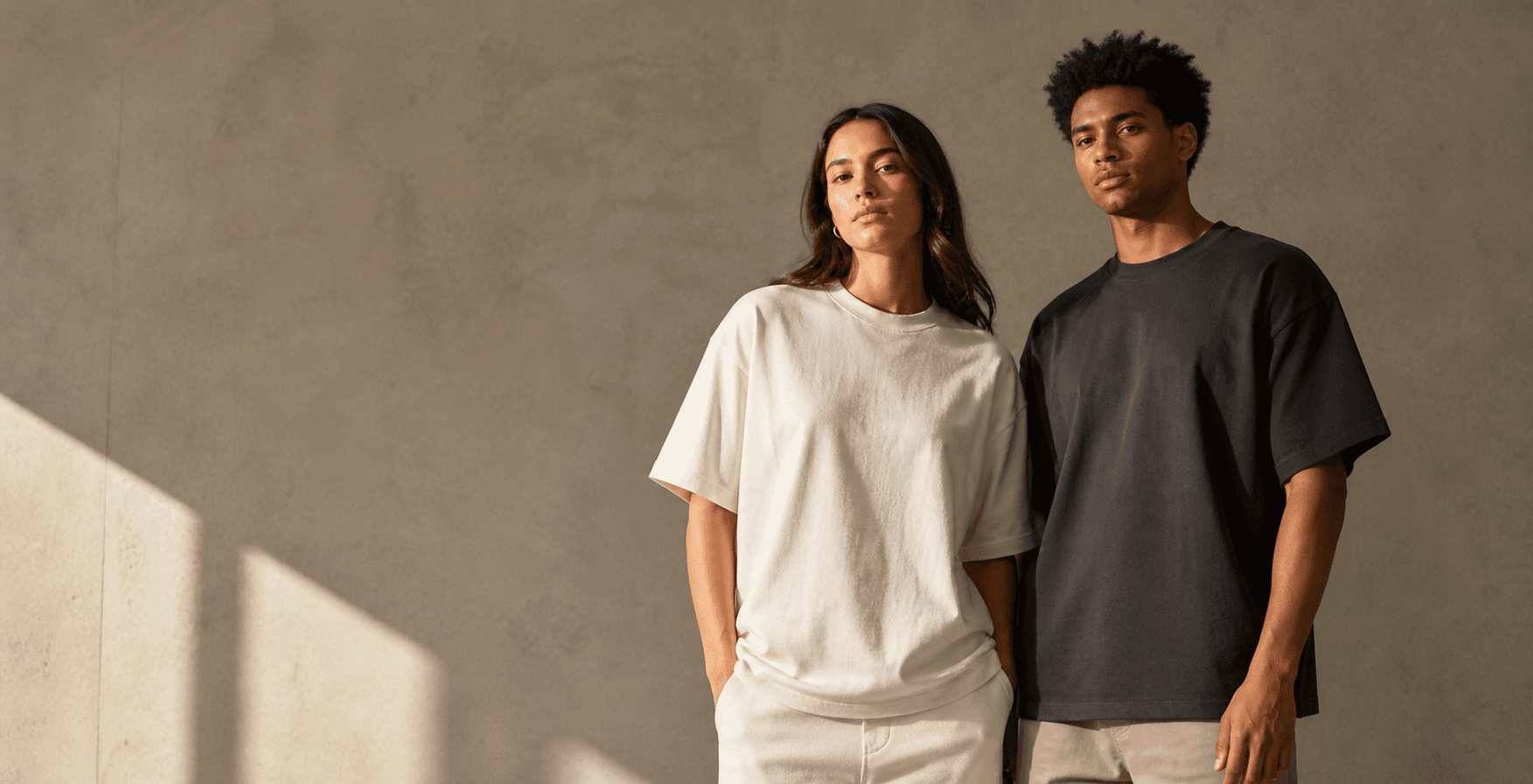 Two models wearing Knitcho essential T-shirts